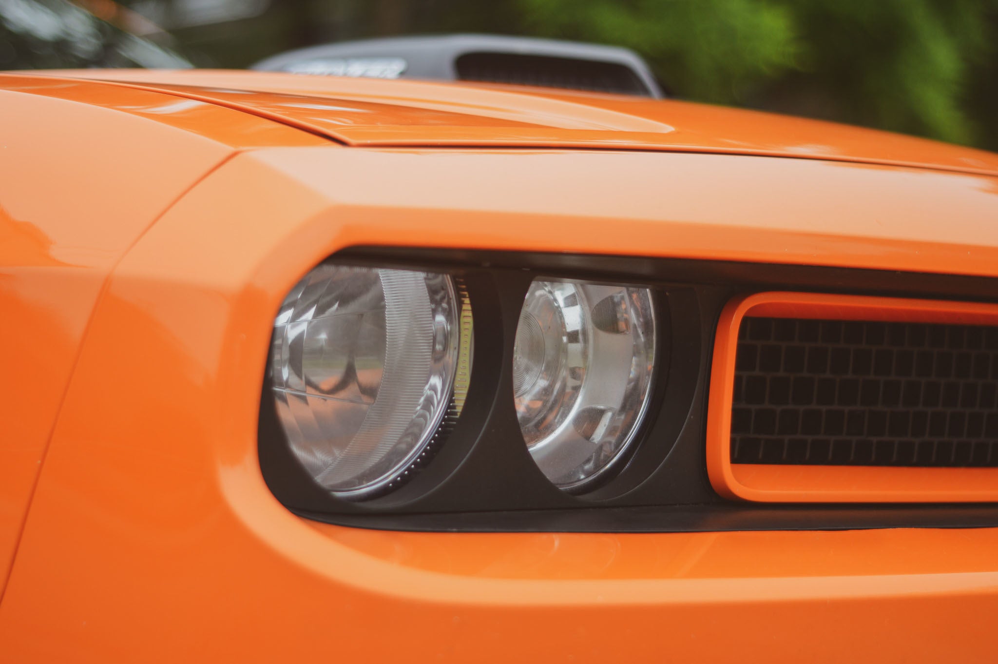 Close-up of an orange muscle car headlight